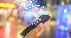 Meribel Transfers 300x159 - Woman hand using smartphone to send and recieve email.